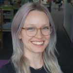 Yasmine Kotturi's headshot with purple hair and pink glasses.